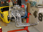 The motor with headers on the stand.