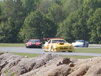 The Dodge, Olds & Corvette going through Turn 3