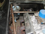 The oil tank is mounted in the engine bay area