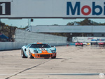 The Gulf GT-40 with our Vette coming down the front straight